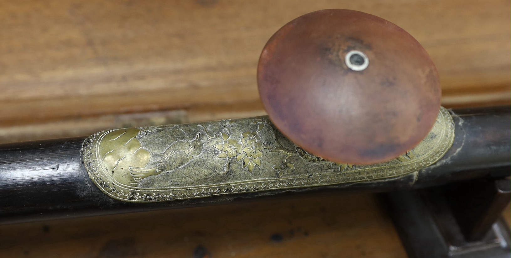 A late 19th/early 20th century Chinese tigers eye mounted opium pipe with stand and box. Box 70cm wide